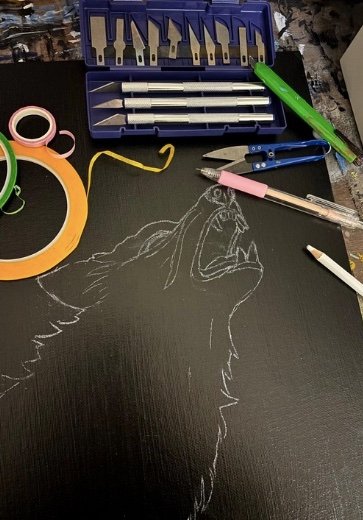 Screenshot Step 2 of Polly Walker's "Stained Glass on Canvas" technique: She gathers her different xacto knives and tapes.